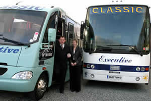 Sam and Esther Hughes with 2 of Classic Coaches luxury vehicles.